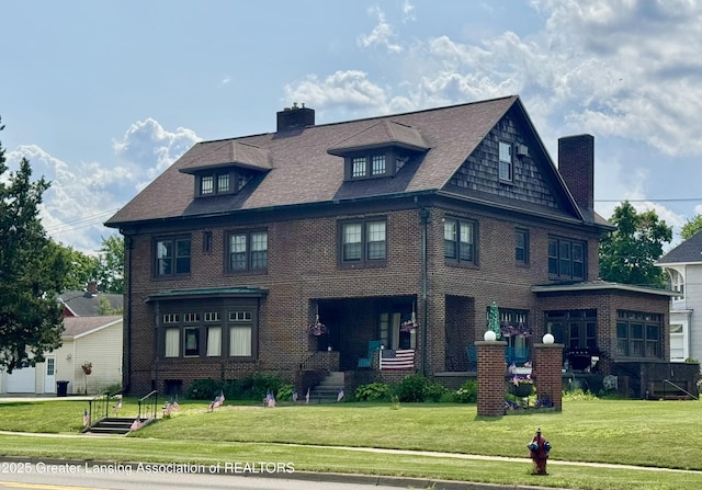 502 S Main St, Eaton Rapids, MI 48827 - view of front of property featuring a chimney, brick siding, and a front yard