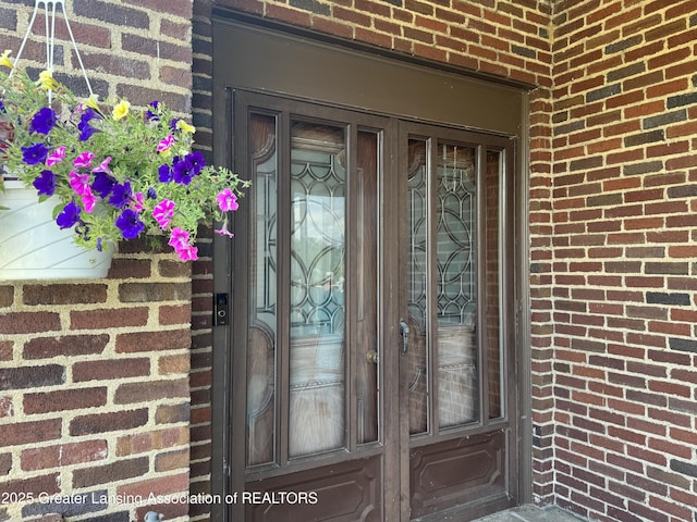 502 S Main St, Eaton Rapids, MI 48827 - doorway to property featuring brick siding