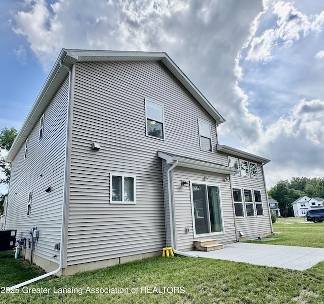 4314 Ringneck Ln, Holt, MI 48842 - back of property featuring a lawn, a patio, and entry steps