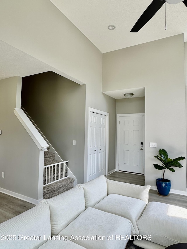 4314 Ringneck Ln, Holt, MI 48842 - living area with wood finished floors, ceiling fan, and stairs