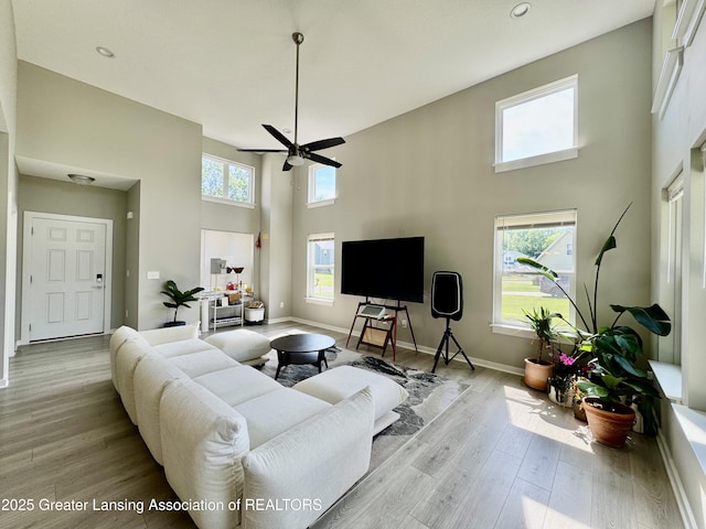 4314 Ringneck Ln, Holt, MI 48842 - living area with a high ceiling, light wood-style flooring, a ceiling fan, and recessed lighting