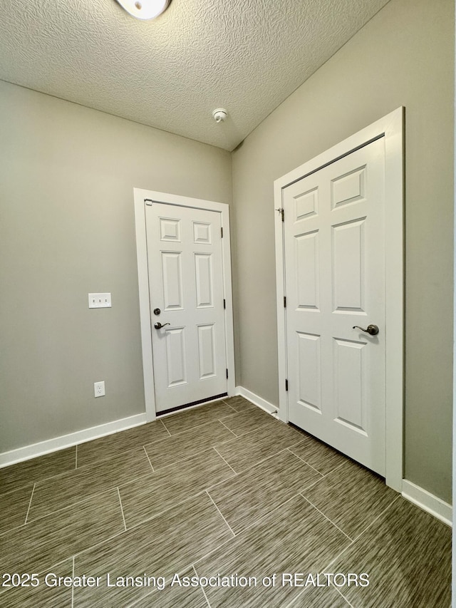 4314 Ringneck Ln, Holt, MI 48842 - entryway with a textured ceiling and baseboards