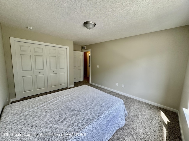 4314 Ringneck Ln, Holt, MI 48842 - bedroom with dark colored carpet, a closet, and a textured ceiling