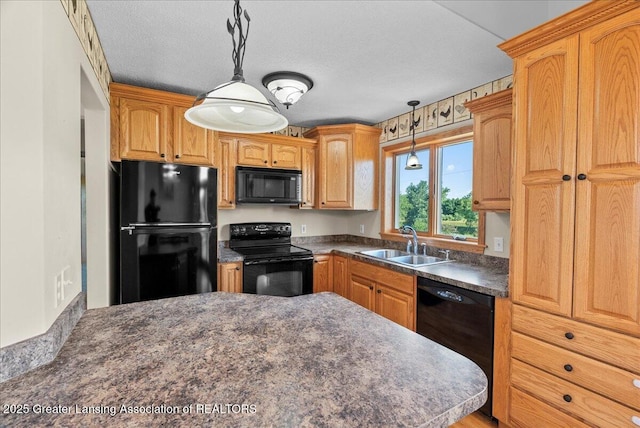 5159 E Pratt Rd, Saint Johns, MI 48879 - kitchen featuring black appliances, dark countertops, and decorative light fixtures