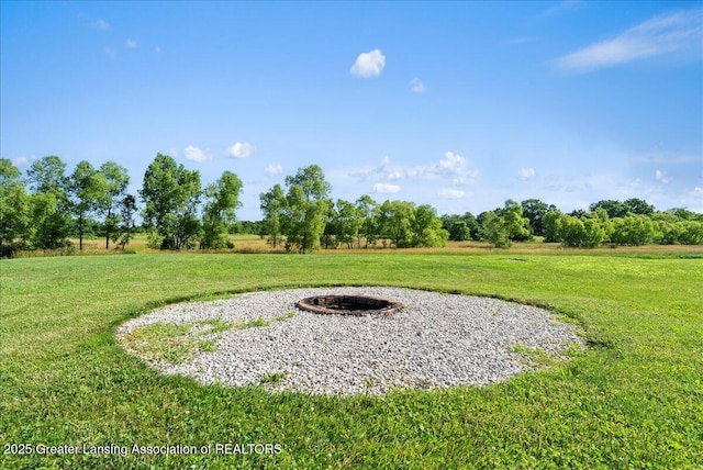 5159 E Pratt Rd, Saint Johns, MI 48879 - view of grassy yard with an outdoor fire pit