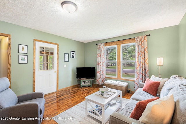 112 Ferry St, Corunna, MI 48817 - living room featuring healthy amount of natural light, wood finished floors, and a textured ceiling
