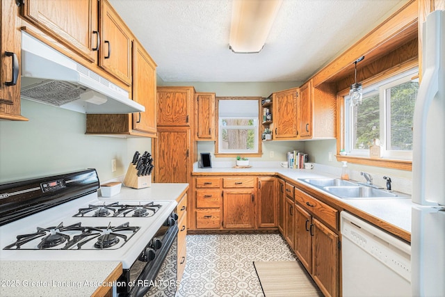 112 Ferry St, Corunna, MI 48817 - kitchen with white appliances, under cabinet range hood, light countertops, pendant lighting, and a textured ceiling