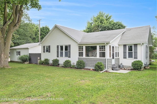 112 Ferry St, Corunna, MI 48817 - back of property featuring a shingled roof and a yard