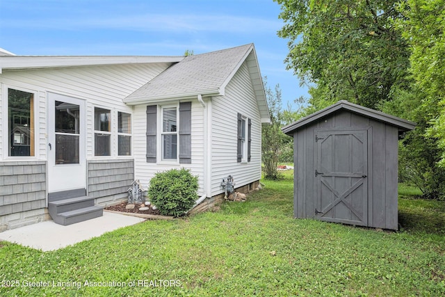 112 Ferry St, Corunna, MI 48817 - view of home's exterior featuring entry steps, a yard, a shed, and a shingled roof