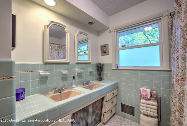4451 Greenwood Dr, Okemos, MI 48864 - bathroom featuring double vanity, wainscoting, and tile walls