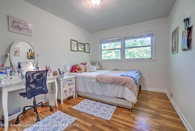 4451 Greenwood Dr, Okemos, MI 48864 - bedroom with a textured ceiling and wood finished floors