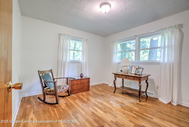 4451 Greenwood Dr, Okemos, MI 48864 - living area featuring a textured ceiling, light wood finished floors, and an office area