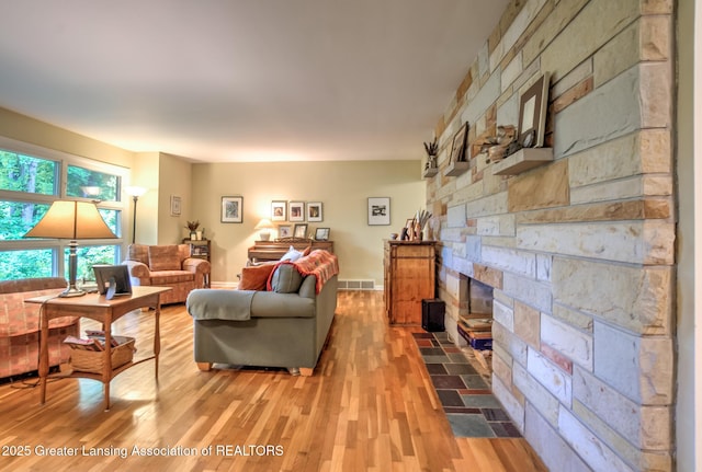 4451 Greenwood Dr, Okemos, MI 48864 - living room with light wood-style floors and a stone fireplace
