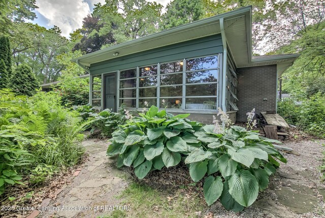 4451 Greenwood Dr, Okemos, MI 48864 - view of side of property with brick siding