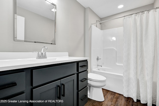 330 Vansickle Dr Unit 31, Charlotte, MI 48813 - bathroom featuring vanity, wood finished floors, shower / bathtub combination with curtain, and recessed lighting