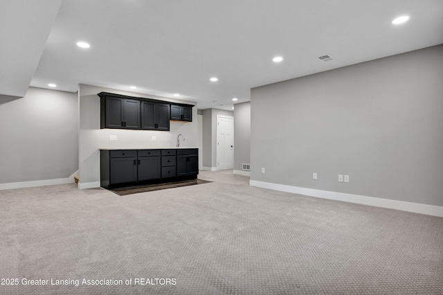 330 Vansickle Dr Unit 31, Charlotte, MI 48813 - indoor wet bar featuring light colored carpet and recessed lighting
