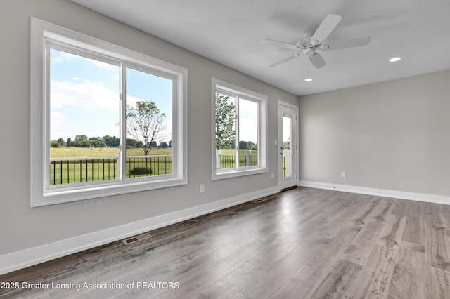 330 Vansickle Dr Unit 31, Charlotte, MI 48813 - empty room with wood finished floors, a ceiling fan, and recessed lighting