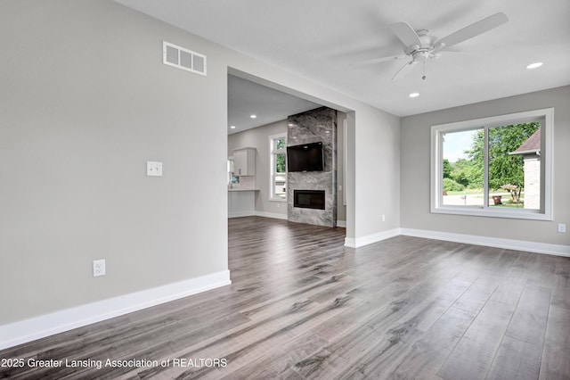 330 Vansickle Dr Unit 31, Charlotte, MI 48813 - unfurnished living room featuring ceiling fan, wood finished floors, a fireplace, and recessed lighting