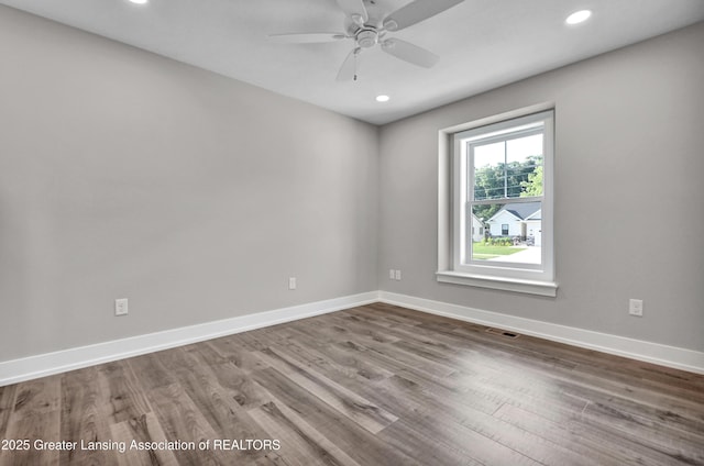 330 Vansickle Dr Unit 31, Charlotte, MI 48813 - spare room featuring wood finished floors, ceiling fan, and recessed lighting