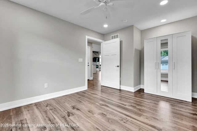 330 Vansickle Dr Unit 31, Charlotte, MI 48813 - unfurnished bedroom featuring recessed lighting, wood finished floors, a closet, and ceiling fan