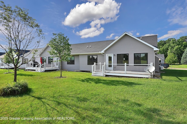 330 Vansickle Dr Unit 31, Charlotte, MI 48813 - back of property with a wooden deck, a lawn, and roof with shingles