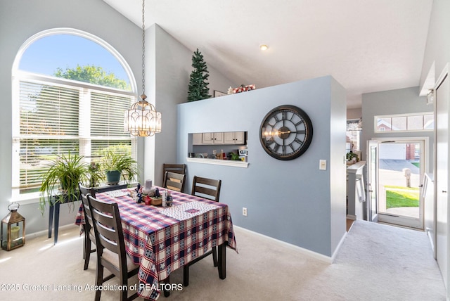 26 Aviemore Dr, Mason, MI 48854 - carpeted dining area featuring a chandelier, healthy amount of natural light, and high vaulted ceiling