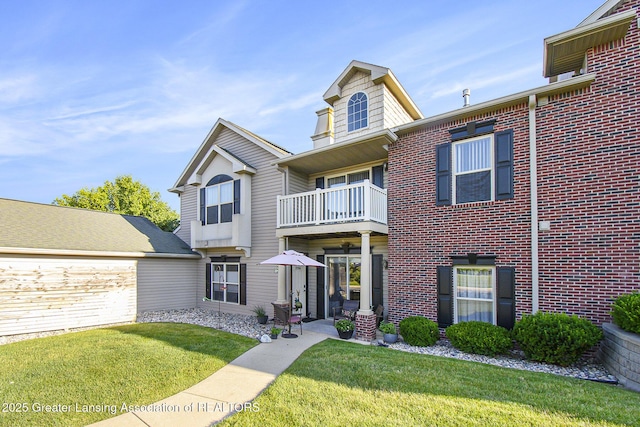 3706 Flying Gulch Dr, Holt, MI 48842 - view of front facade featuring a balcony, a front yard, and brick siding