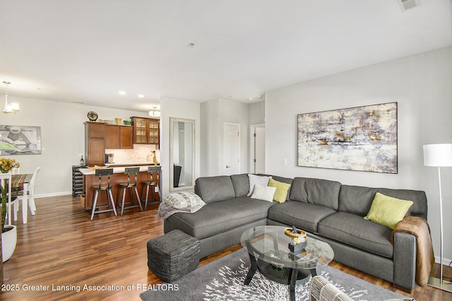 3706 Flying Gulch Dr, Holt, MI 48842 - living area with dark wood-style floors, a chandelier, and recessed lighting