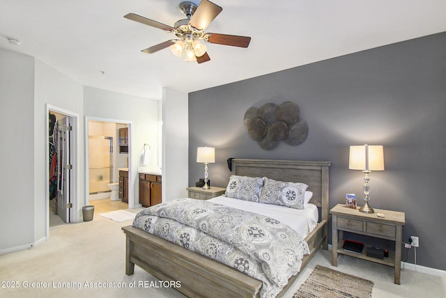 3706 Flying Gulch Dr, Holt, MI 48842 - bedroom featuring light colored carpet, a spacious closet, a closet, connected bathroom, and ceiling fan