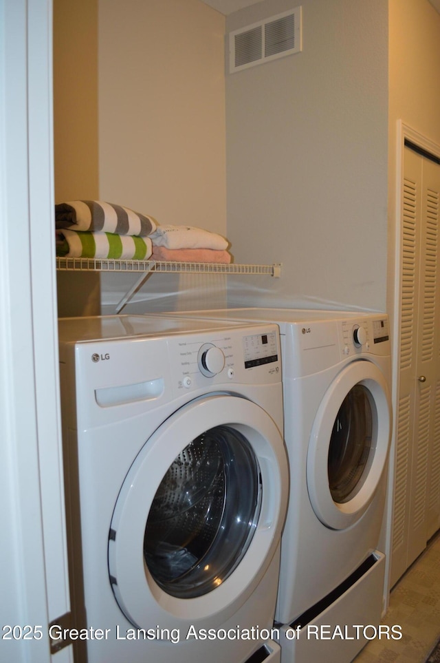 3706 Flying Gulch Dr, Holt, MI 48842 - washroom featuring washing machine and dryer and wood finished floors