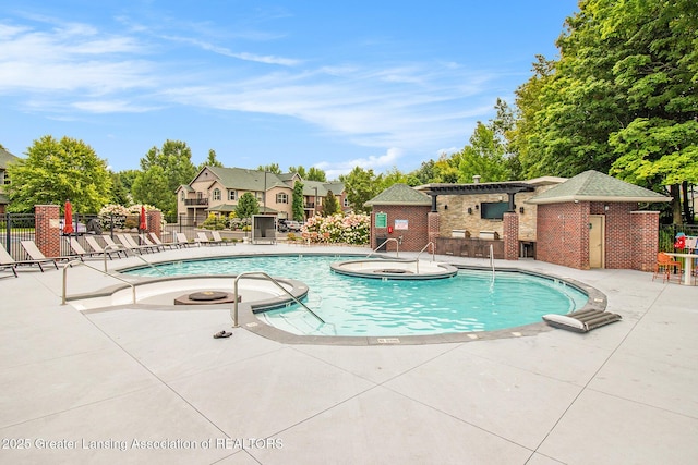 3706 Flying Gulch Dr, Holt, MI 48842 - community pool featuring a jacuzzi and a patio area