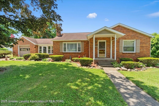 816 N Waterloo Ave, Jackson, MI 49202 - ranch-style home with brick siding, a front lawn, and an attached garage