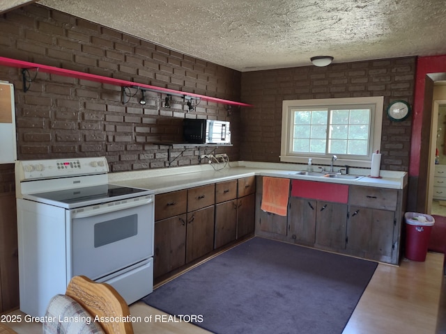 16711 Stark Rd, Springport, MI 49284 - kitchen featuring electric stove, a textured ceiling, and light countertops