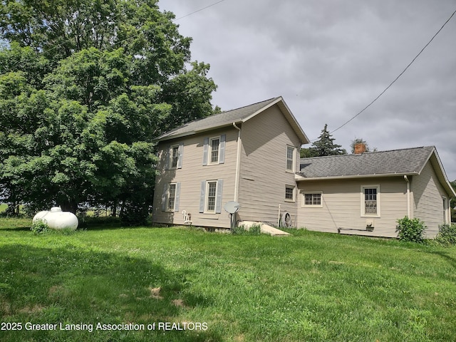 16711 Stark Rd, Springport, MI 49284 - back of property featuring a lawn, a chimney, and roof with shingles