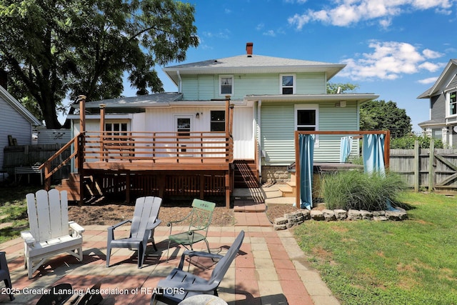 302 E State St, Saint Johns, MI 48879 - rear view of property featuring a deck, a patio area, a chimney, and stairway