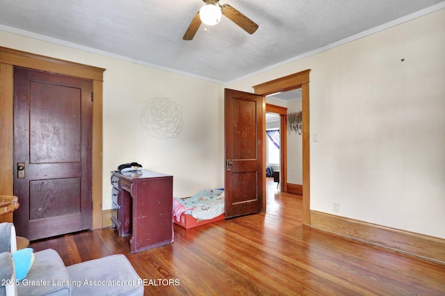 302 E State St, Saint Johns, MI 48879 - living area with a ceiling fan, wood finished floors, and ornamental molding