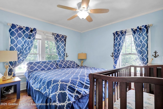302 E State St, Saint Johns, MI 48879 - bedroom featuring wood finished floors, multiple windows, crown molding, and ceiling fan