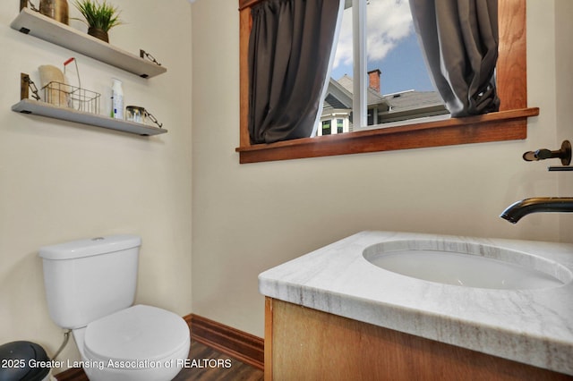302 E State St, Saint Johns, MI 48879 - bathroom featuring vanity and wood finished floors