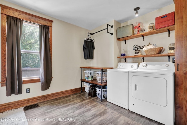 302 E State St, Saint Johns, MI 48879 - washroom with washing machine and clothes dryer and wood finished floors