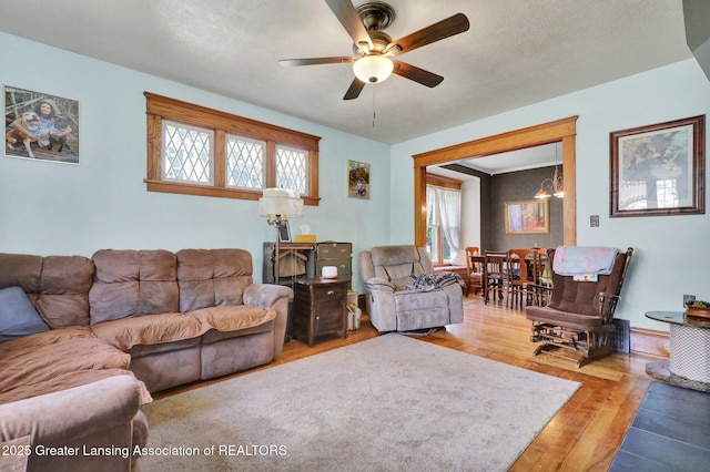 302 E State St, Saint Johns, MI 48879 - living room with healthy amount of natural light, hardwood / wood-style flooring, a ceiling fan, and a chandelier