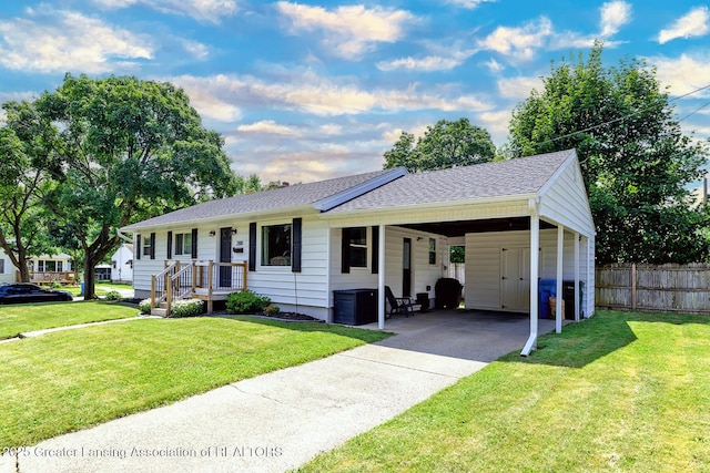 2818 Almar Ln, Lansing, MI 48910 - ranch-style house with driveway, an attached carport, and roof with shingles