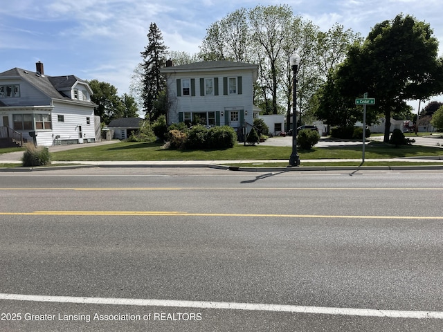 2111 Cedar St, Holt, MI 48842 - view of front of house with a front lawn