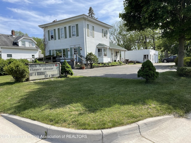 2111 Cedar St, Holt, MI 48842 - view of front facade with a front lawn