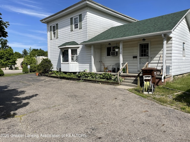 2111 Cedar St, Holt, MI 48842 - view of front of home featuring roof with shingles and a porch