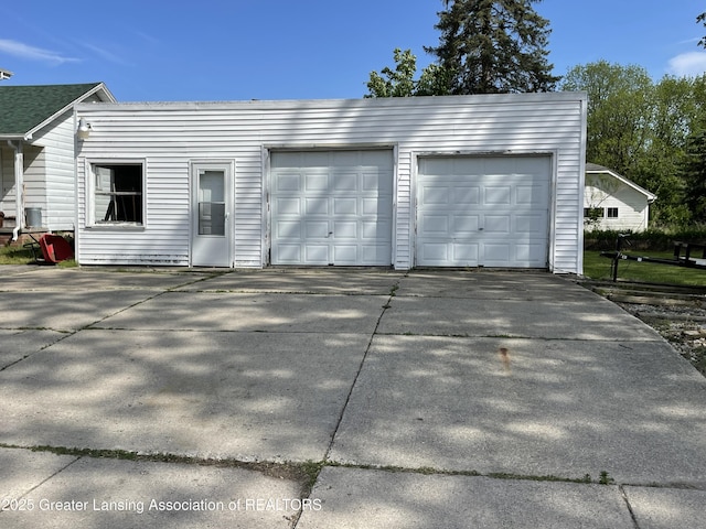 2111 Cedar St, Holt, MI 48842 - garage with concrete driveway