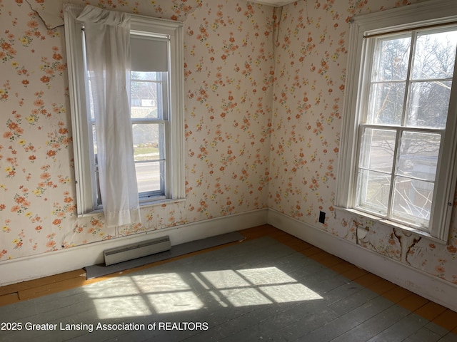 2111 Cedar St, Holt, MI 48842 - spare room featuring healthy amount of natural light, wood-type flooring, and wallpapered walls