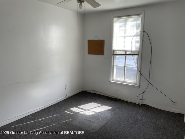2111 Cedar St, Holt, MI 48842 - empty room featuring dark carpet and a ceiling fan