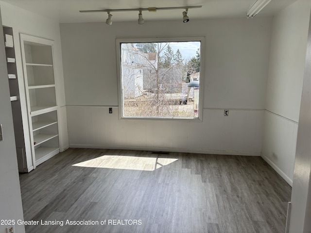 2111 Cedar St, Holt, MI 48842 - unfurnished room featuring wood finished floors and track lighting