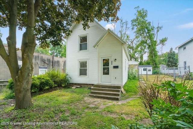 625 W Jefferson St, Grand Ledge, MI 48837 - back of house with entry steps and an outbuilding