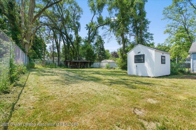 625 W Jefferson St, Grand Ledge, MI 48837 - fenced backyard featuring a storage unit